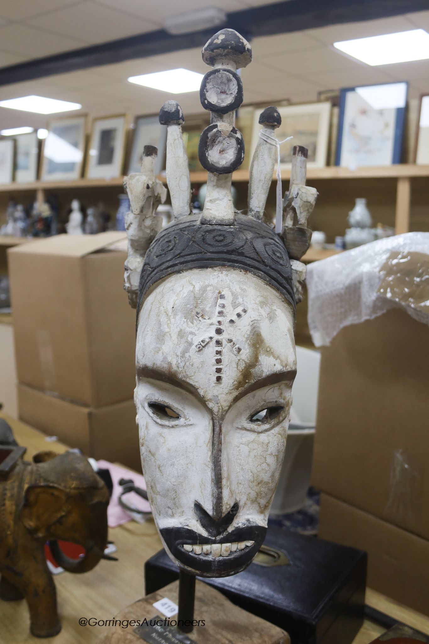 A Nigerian Ibo Maiden style mask, on stand, height 79cm